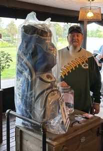 Tim Regis with the Detroit Lions golf bag he donated